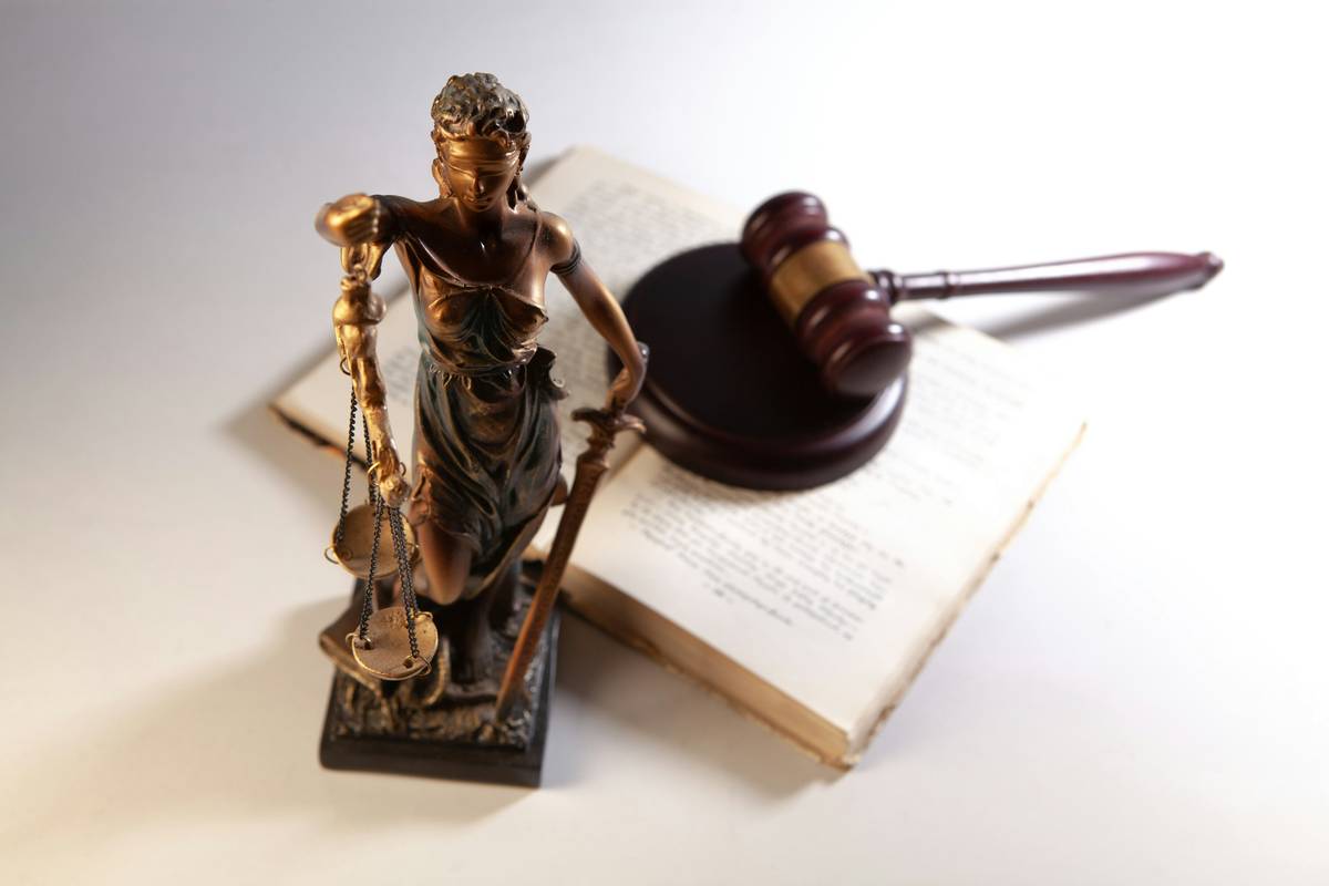 Graphic showing digital content creator reviewing contract with Defamation Claims Coverage highlighted in red